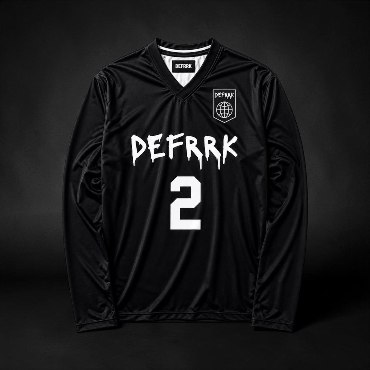 A black long-sleeve soccer jersey with 'DEFFRK' and the number '2' printed in white on the front, featuring a small crest on the left chest, displayed against a dark studio background.